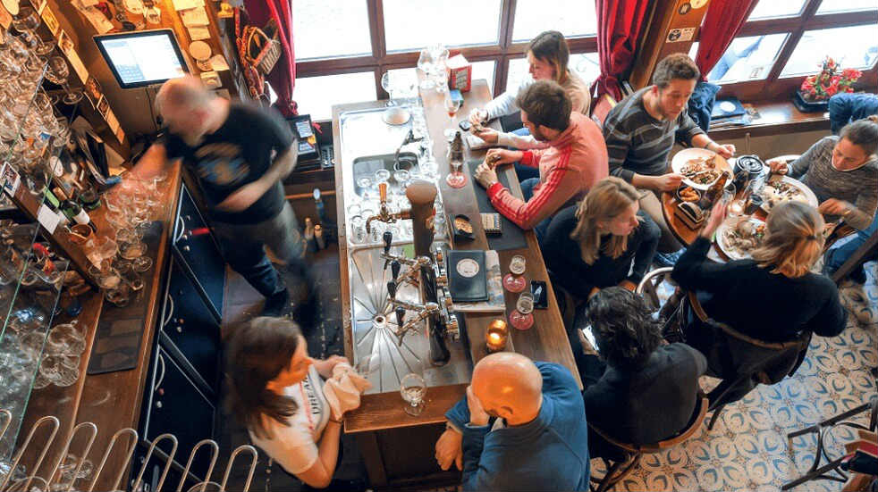 Monthly Group Lunch at the College Oak, Abingdon people sitting round table eating drinking and chatting